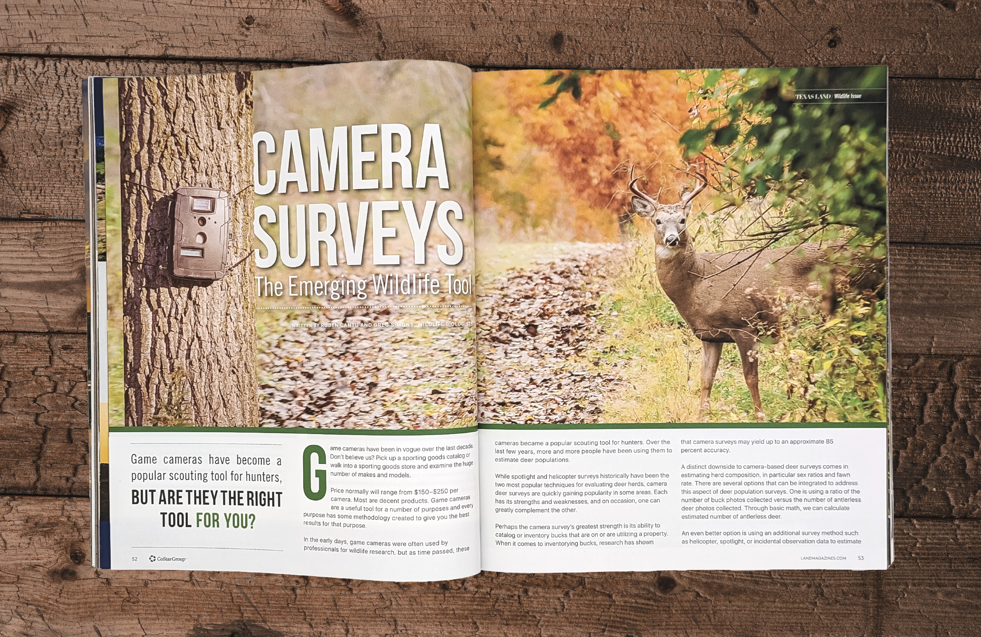A magazine on a wooden surface open to an editorial spread titled Camera Surveys: The Emerging Wildlife Tool. The image that spans the entire spread has a survey camera on the left hand side and a whitetail deer peeking out of some greenery on the right.