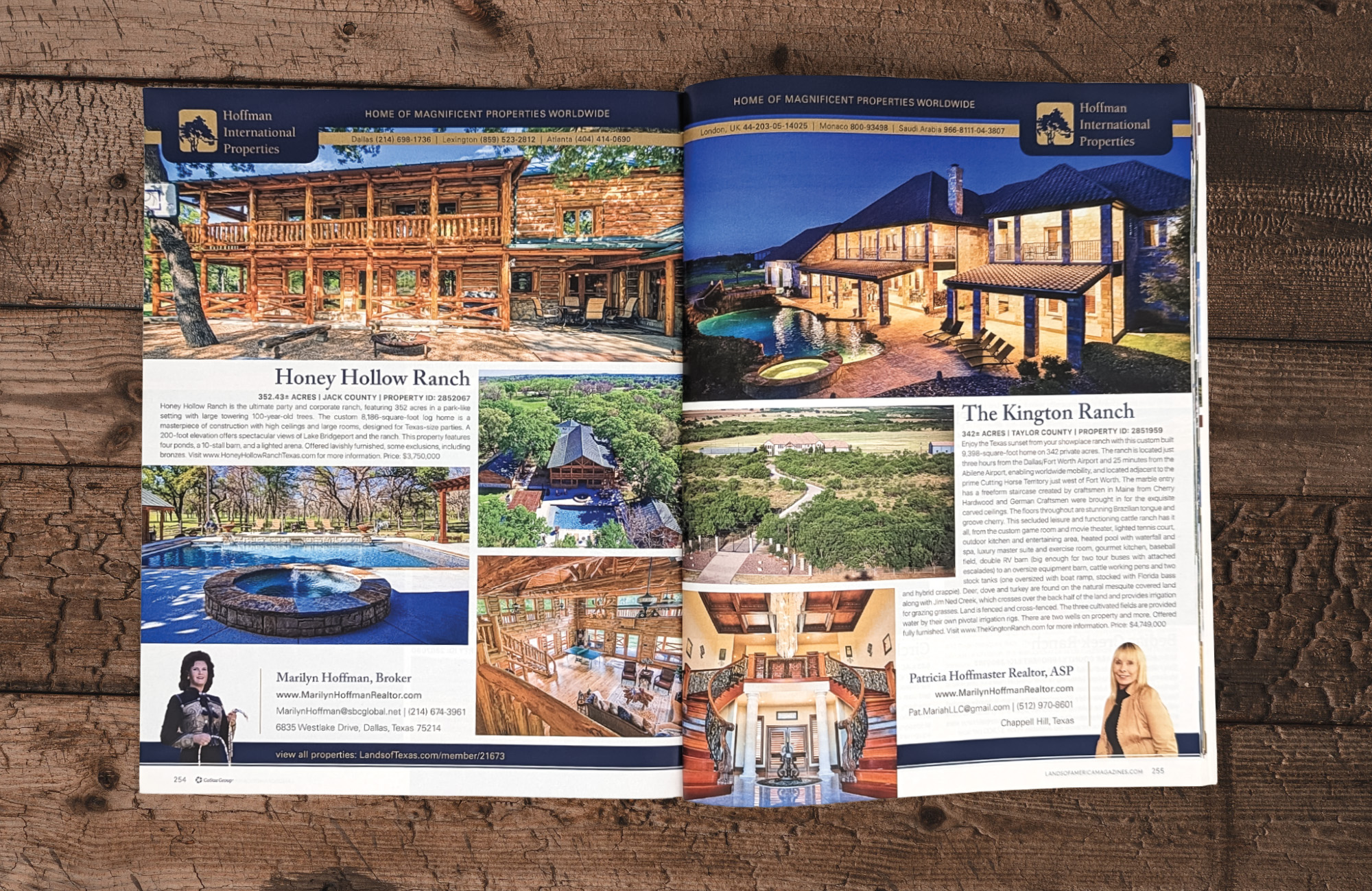 A magazine on a wooden surface open to a spread for property listings for Hoffman International Properties. The left page is for a multimillion dollar log cabin style mansion while the right page is for a multimillion dollar stone exterior mansion.
