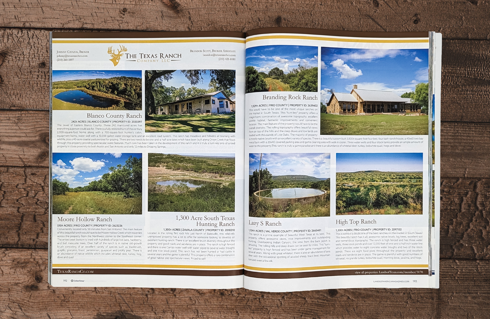 A magazine on a wooden surface open to a spread for property listings for The Texas Ranch Company. There are six property listings spanning across two pages.